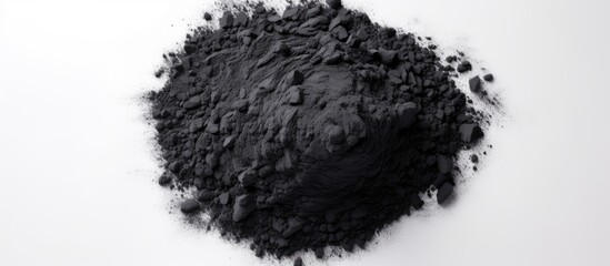 Black charcoal particles isolated on a white background top view Activated charcoal powder. Copy space image. Place for adding text