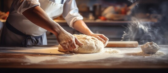 Close up view of baker cutting bread dough with steel scraper in bakery. Copy space image. Place for adding text - obrazy, fototapety, plakaty