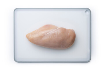 Close-up of chicken fillet on a light cutting board