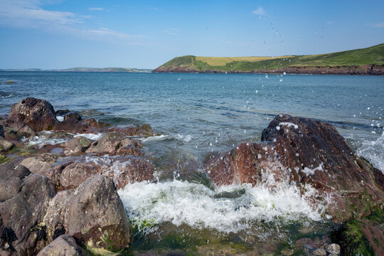 Sea waves crashing against the rocks on Manorbier Beach pembrokeshire