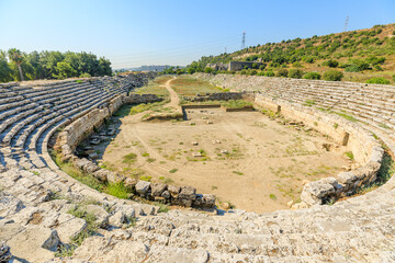 Fototapeta na wymiar Aerial view on well-preserved ruins of the stadium of Perge City of Turkey. Once accommodated thousands of spectators who gathered to enjoy performances and entertainment.