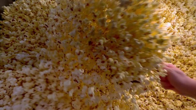 Stir up fresh popcorn - freshly made cinema popcorn in a movie theater - stock photography