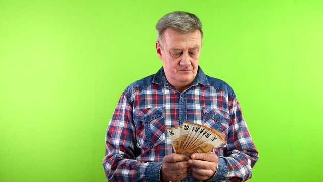 Senior man counting cash 50 euro money banknotes.