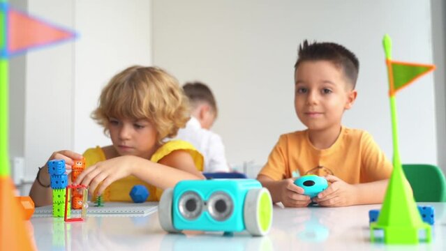 Children playing with toy car control panel in STEM educational class. Preschool kids exploring technology first steps