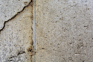 Close up textured background of a cracked concrete block