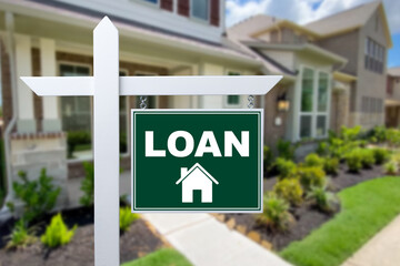 LOAN sign against a house. Close-up.