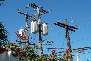 Column or post as a utility pole with a single-phase distribution transformer made out of wood and...