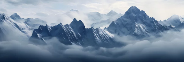 Deurstickers a panoramic view of snowy mountains with snow covered peaks covered with fog and snow in winters © DailyLifeImages