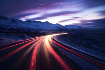 a highway road with cars moving fast with motion blur between snowy mountains