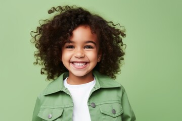 Happy little african american girl with curly hair, isolated on green background