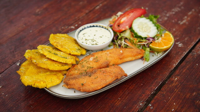 Costa Rican Fried Fish Casado With Salad and Smashed Plantains 
