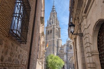 The Primatial Cathedral of Saint Mary of Toledo appears through the streets in historic Toledo, Spain - 691219902