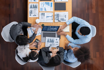 Top view multiracial analyst team use BI dashboard display on laptop screen, analyzing financial data for strategic decision. Fintech analyzes marketing indicators. Concord