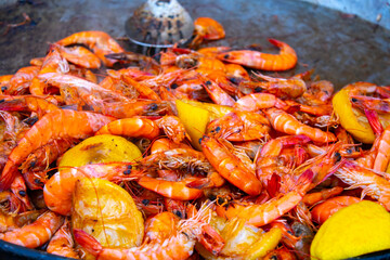 Appetizing grilled shrimps with herbs prepared in pan