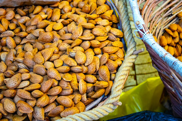 Fresh almonds nut on a wooden table in the summer garden