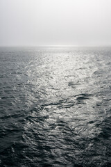Peaceful early morning fog over the arctic ocean, water to the foggy horizon, as a nature background
