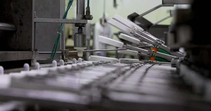 Food industry. Automation and technology. Industrial ice cream production process. View of a cream popsicle factory machine transporting the creamsicles.