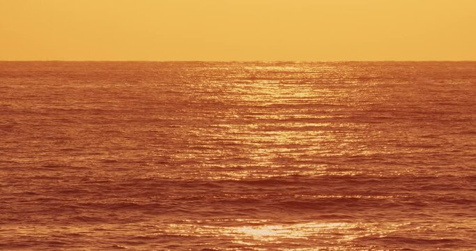 Sunset sunrise light in sea water surface.Sunrays flickering in ocean shimmering sea waves in sun Abstract background,Amazing autumn and summer background,seamless loop nature video background