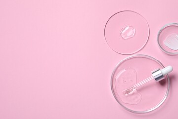 Pipette, cosmetic serum and petri dishes with samples on pink background, flat lay. Space for text