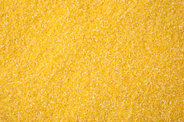 Raw corn grits as background, top view