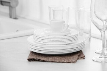 Clean dishes on light countertop in kitchen