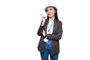 Beautiful female worker wearing a helmet pointing to the side isolated transparent