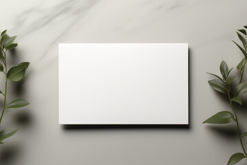 Blank white card mock-up over textured background with leaves