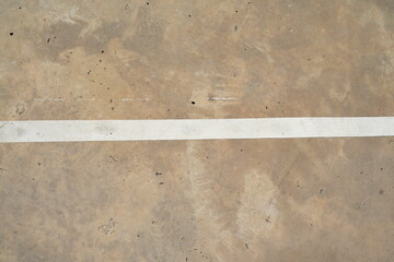 White lines, peeling paint on the cement floor of the old stadium
