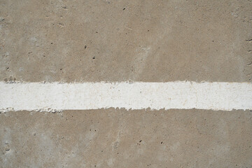 White lines, peeling paint on the cement floor of the old stadium