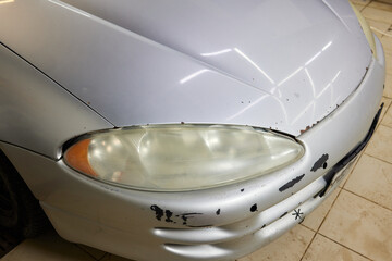 Big headlight cleaning on the car with power buffer machine at service station ,Before and after...