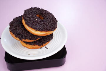Sweet chocolate donut on white plate