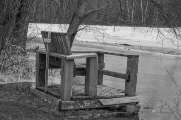 Wooden chair by the frozen lake in the winter