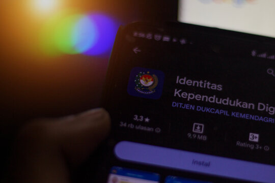 pringsewu, Lampung; December 11, 2023, a man's hand holds a cellphone with the Digital Population Identity (IKD) logo on the cellphone screen. selective focus screen. Illustrative Editorial