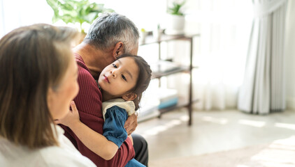 Portrait of happy love asian grandfather with grandmother and asian little cute girl enjoy relax at...
