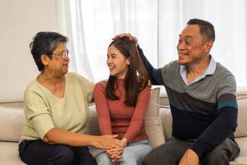 Portrait enjoy happy smiling love asian family.Senior mature father hug with elderly mother and young adult woman play laughing and having fun together at home.insurance concept.