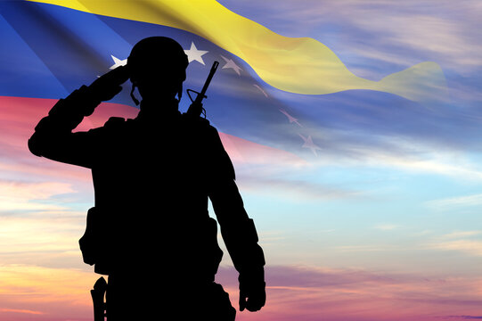 Silhouette of a soldier with Venezuela flag against the sunset