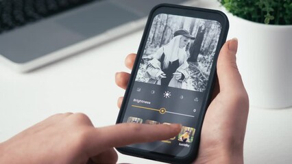 Woman editing her photo for social media. Stylizing images using an online app, choosing between different photo filters. Fictional interface.