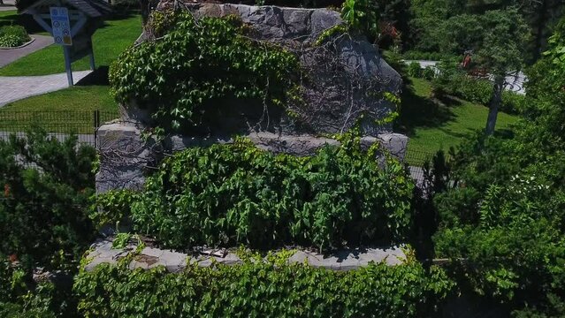 Cullen Central Park with Old Mill Building Covered in Ivy, Aerial Pedestal Drone Shot, Canada.