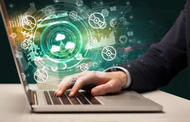 Business hand typing on a modern laptop