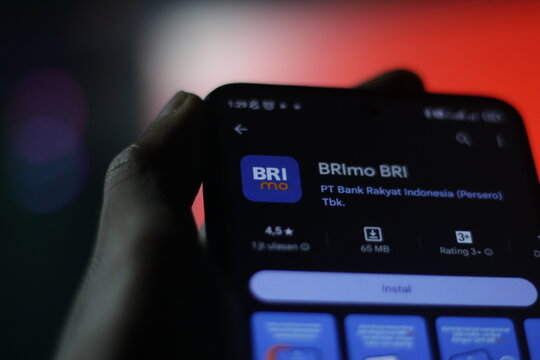 pringsewu, Lampung; December 11 2023, a man's hand holds a cellphone with the BRImo BRI apps logo on the cellphone screen. selective focus screen. Illustrative Editorial