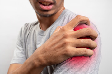 Man feels pain his shoulder isolated studio shot. Pain points are highlighted in red. isolated...