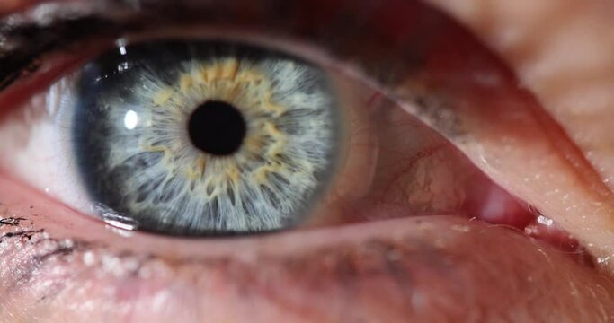Blue and gray colored woman with one eye wide open.