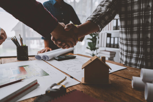 Architect and engineer construction workers shaking hands after successful collaboration. working site, Construction, contract between two companies structure concept