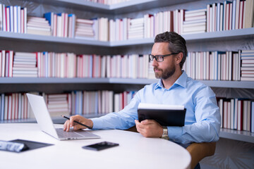 Teacher in classroom. Knowledge and education with handsome teacher. Teacher with book in classroom. Man on lesson in class. Teachers from university exam. College teacher. Teaching and learning.