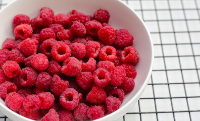 Fresh raspberry on white background.