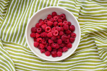 Fresh raspberry in white bowl