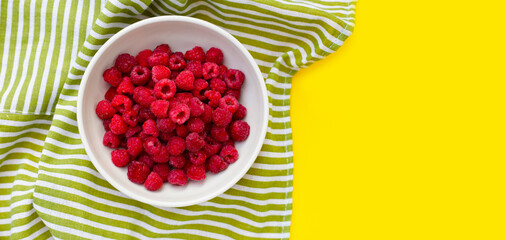 Fresh raspberry on yellow background.