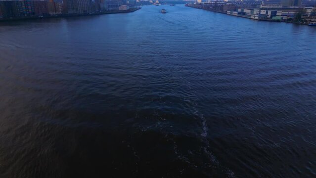 Revealing Aerial Shot over North Sea Canal in Amsterdam with a Tanker Ship coming, Twilight