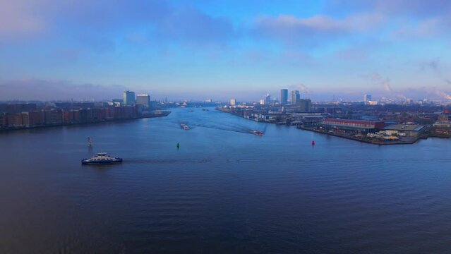 Aerial Panoramic Urban View over North Sea Canal with some Ships in Amsterdam City, Twilight