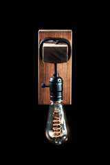 Vintage wall lamp to illuminate the terrace. Antique lamp with Edison bulb. The concept of saving...
